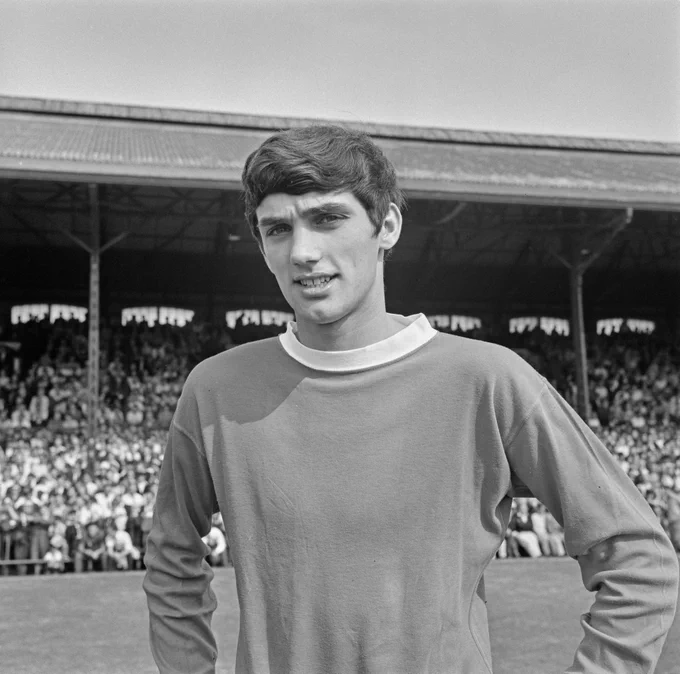 George Best poses for a photo in United kit.