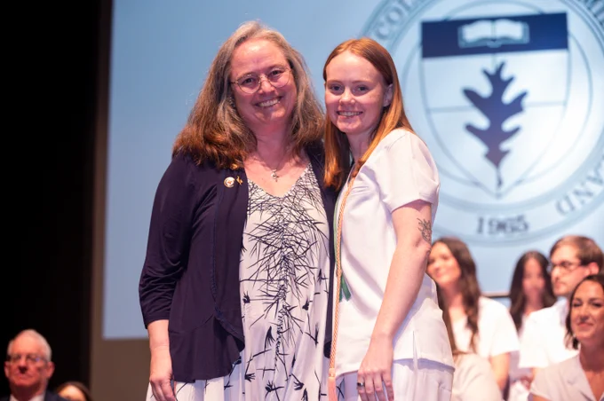 a Nursing Program graduate poses for a picture with one of her instructors