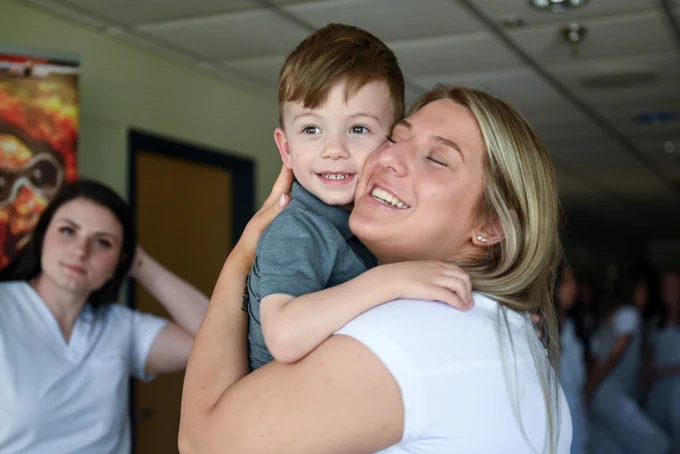 a Nursing Program graduate is all smiles as she celebrates with family and friends