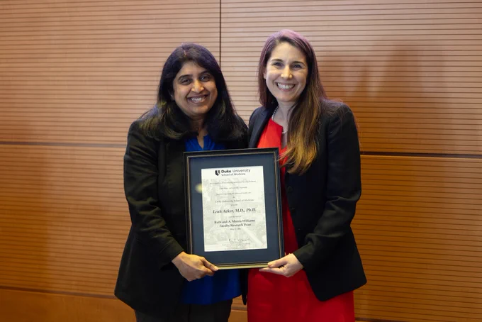 Duke Anesthesiology interim chair, Dr. Padma Gulur, posing with Dr. Leah Acker with her SoM Faculty Award.