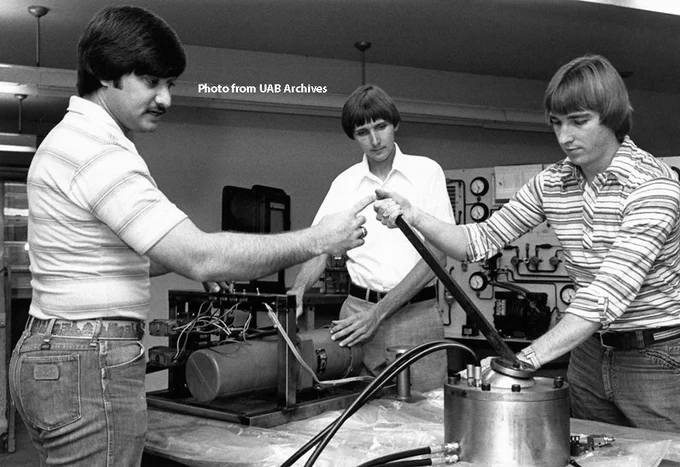 group of students working on an engineering project in the 1970s.