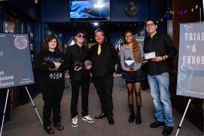 RSC Professor Marcus Mallard stands in the center of four students holding awards at the annual RSC Film Studies & Digital Media awards.