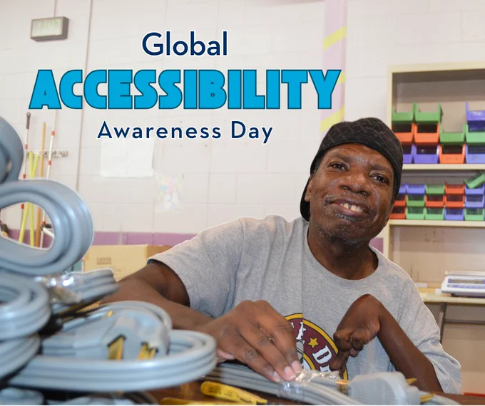Man assembling electrical components in a workshop setting promoting Global Accessibility Awareness Day.