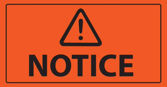 An orange sign with a triangle and exclamation point, and the word "notice" written on it. 