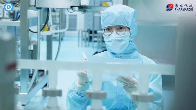 Full-Service Gene Therapy Support. Image of a person in protective gear working in a cleanroom environment with various lab equipment and machinery. The Pharmaron logo is visible, highlighting the company's meticulous and sterile conditions for gene therapy support