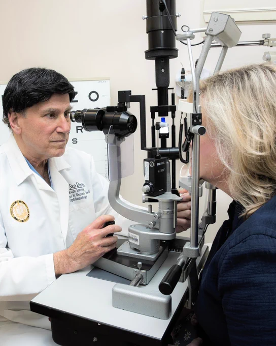 Robert N. Weinreb, MD examining patient using slit lamp.