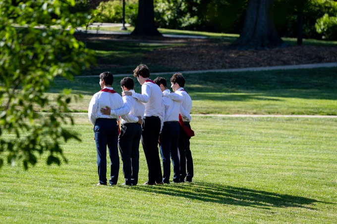 A quartet of Terp graduates pose on McKeldin Mall