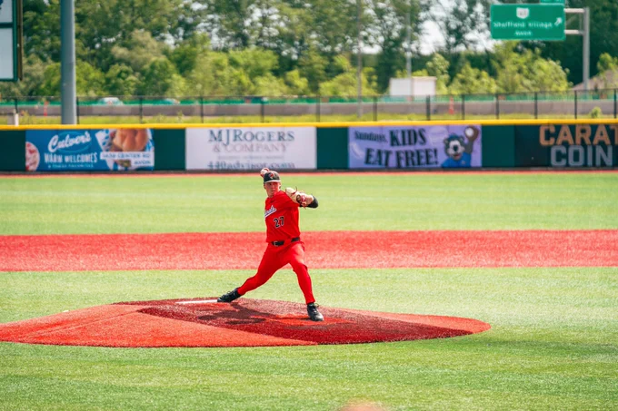 John Chambers in a red Ball State baseball uniform throwing a pitch