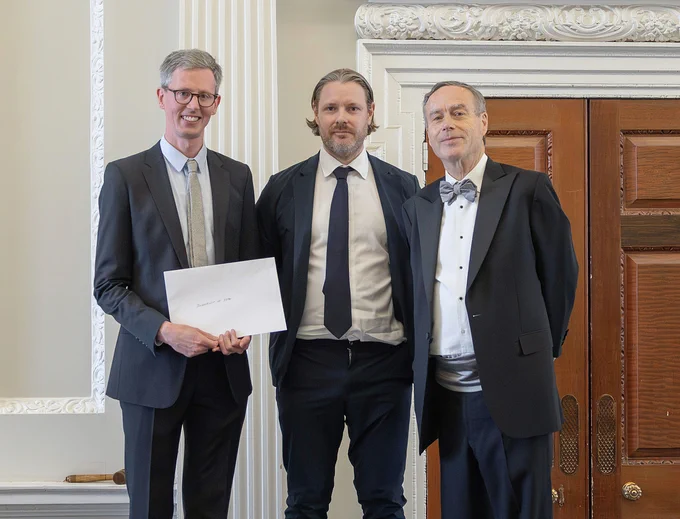 Jonathan Browning and Harry Wilson accept the Journalism of the Year award from the Wincott Foundation's chairman Lionel Barber, former editor of the Financial Times.