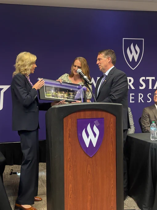Board Chair Amanda Covington presenting Chris Mallett with a gift at the Weber State Presidential Announcement