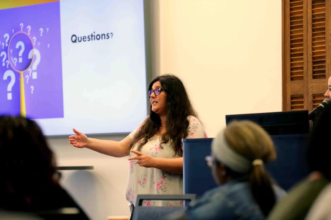 Pictured is a photo of a person giving a presentation to U T A Libraries staff members at the Lunch and Learn event on May 21.