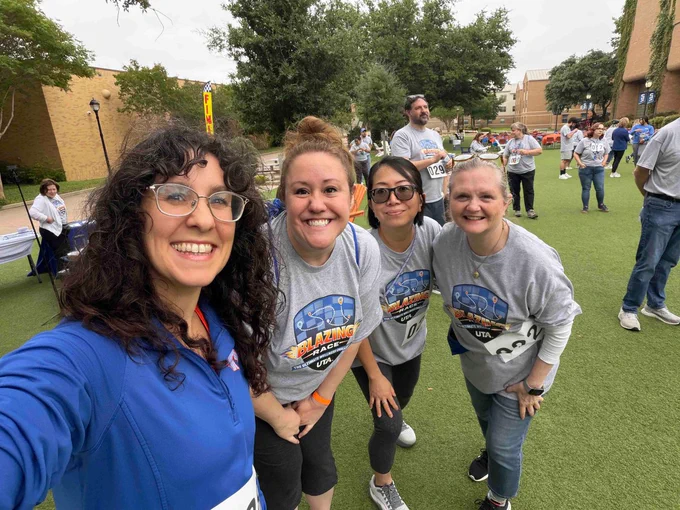 Pictured is a group photo of four UTA Libraries staff members at the Blazing Race event.