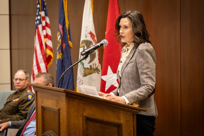 Gov. Whitmer speaks to Gold Star Families at a podium.