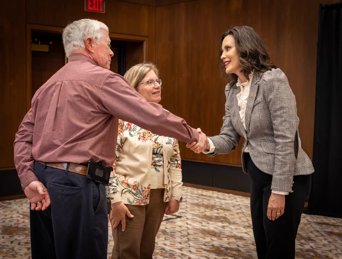 Gov. Whitmer shakes the hand of a man.