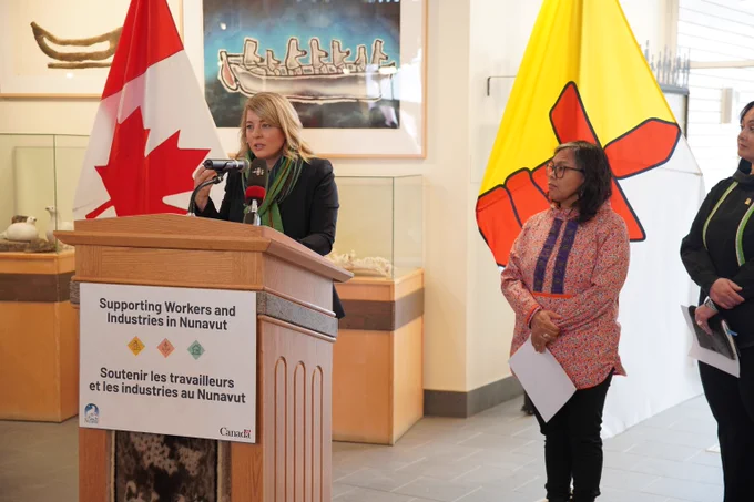 Minister Joly speaking at the podium