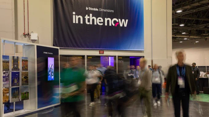 People walking inside of the exhibit hall at Trimble Dimensions.