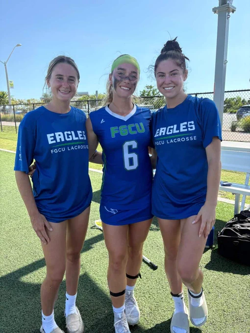 a photo of three fgcu women's lacrosse players smiling on a field 