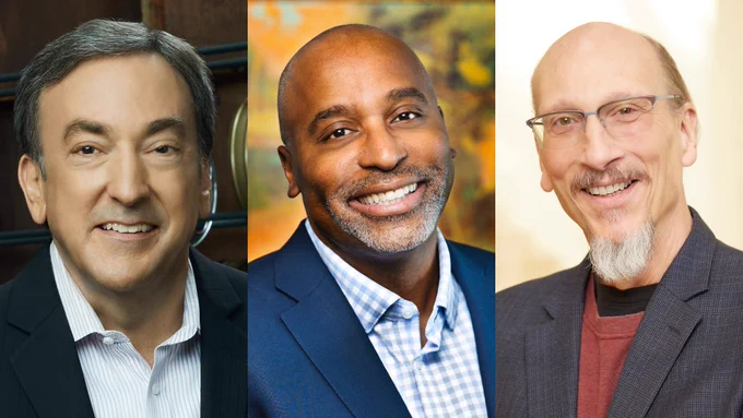 Headshot portrait of three smiling men arranged side by side. On the left is a man with dark hair wearing a dark blazer over a white pinstriped shirt. In the center is a man with a warm smile wearing a navy blazer over a white and blue checkered shirt. On the right is a man wearing glasses and a charcoal-grey blazer over a rust-colored shirt.