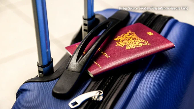 Traveler luggage with passport and travel documents placed on a suitcase at an international airport during rising global travel restrictions in 2026. The image represents emergency visa measures, stricter immigration checks, airport security procedures, and sudden international travel rule changes affecting passengers worldwide. It highlights concerns around delayed visa approvals, additional document verification, border screening, and changing entry requirements for international travelers. The airport travel setup symbolizes uncertainty in modern air travel as governments introduce temporary visa restrictions and enhanced immigration controls. Suitable for articles discussing visa policy updates, airport disruptions, travel advisories, international flight planning, and global travel challenges in 2026.