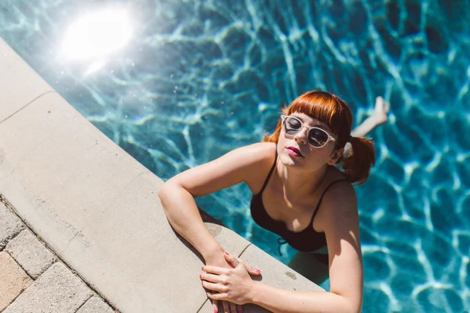 Model wearing sunglasses in pool