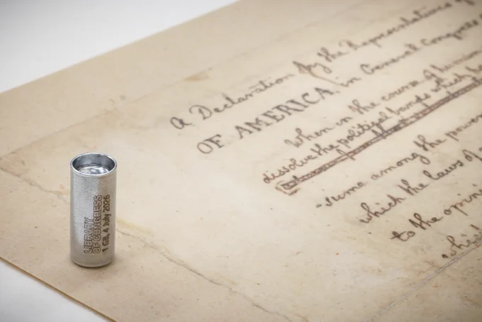 A one gigabyte synthetic DNA storage pellet encoded with digital copies of Library collection items is displayed alongside Thomas Jefferson's handwritten draft of the Declaration of Independence, one of the many items molecularly stored, May 14, 2026. The DNA pellet will be buried in a time capsule in Philadelphia to mark America's 250th birthday, and is set to be reopened in 2276. Photo by Shawn Miller/Library of Congress. 