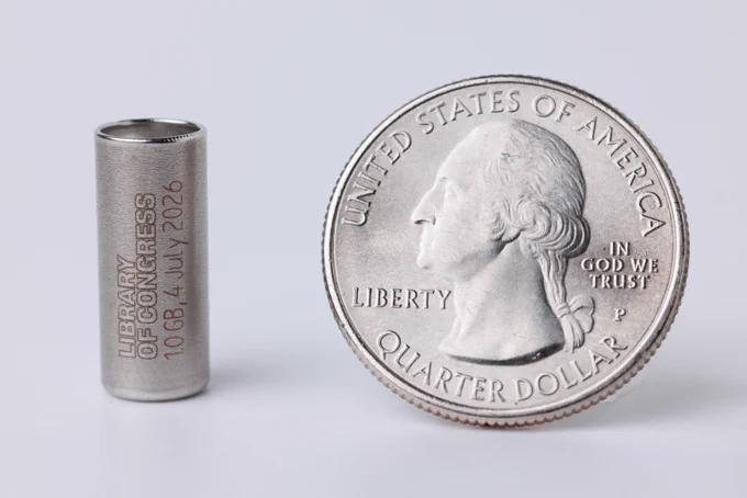A one gigabyte synthetic DNA storage capsule containing digitized versions of Library of Congress collections treasures (next to a U.S. quarter for scale), is prepared to be included in a time capsule for America's 250th anniversary this summer. Photo by Shawn Miller/Library of Congress. 