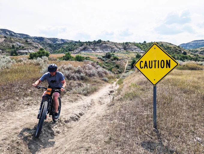 Playing it safe while still flirting with the wild, this Maah Daah Hey 100 rider proves every trail has a story. Ready to diverge from your own beaten path? Consider becoming the CCC Campground Host this summer. Forest Service photo by Scott C. Marvin.