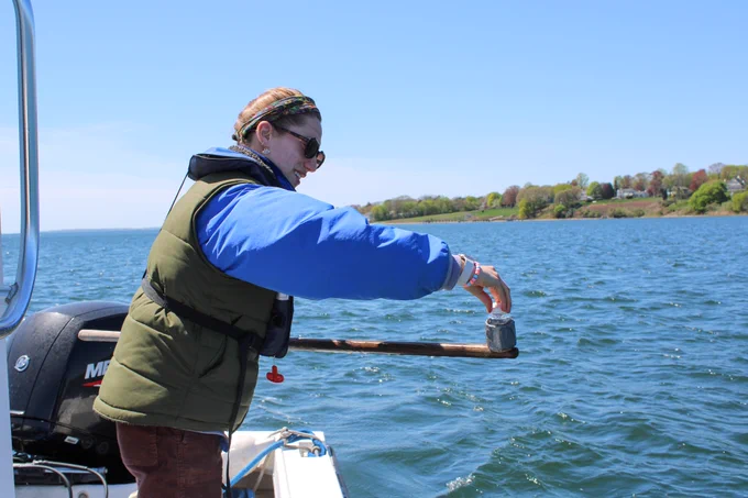  Environmental Scientist Olivia from DEM’s Shellfish Water Quality Program collecting a water sample for testing