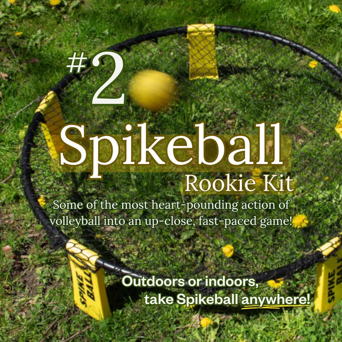 A yellow ball bounces off a circular net, which is set up on green grass with dandelions. Text overlays in the centre read "#2 Spikeball Rookie Kit" and " Some of the most heart-pounding action of volleyball into an up-close, fast-paced game!" Text in the bottom right reads, "Outdoors or indoors, take Spikeball anywhere!"