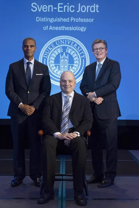 Sven-Eric Jordt, PhD, Distinguished Professor of Anesthesiology, with Duke University President Vincent Price (right) and Provost Alec Gallimore (left) at the professorships ceremony on May 18.