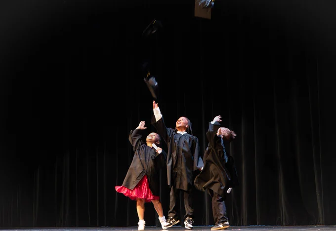 The Barker graduates tossing their caps into the air.