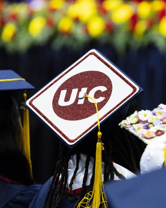 A graduation cap with a bedazzled UIC logo