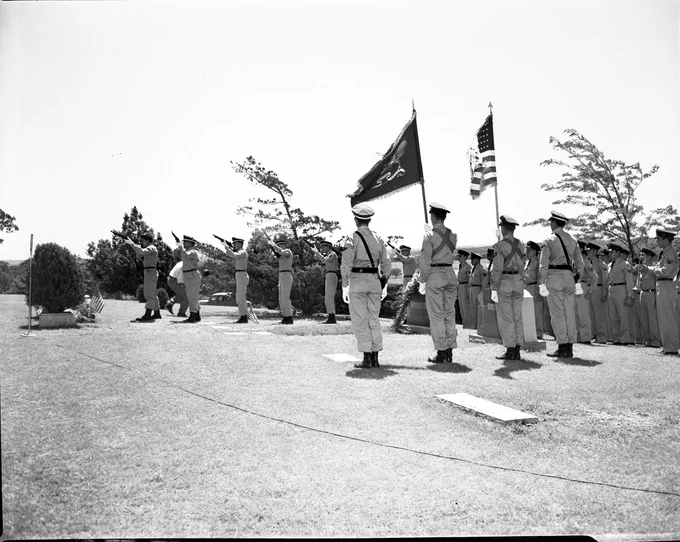 Pictured is a photo that shows Memorial Day services held in Rose Hill Cemetery for Major Horace Carswell, for whom Carswell Air Force Base is named. The photo shows an honor guard with flags and a rifle squad shooting a three-volley salute.