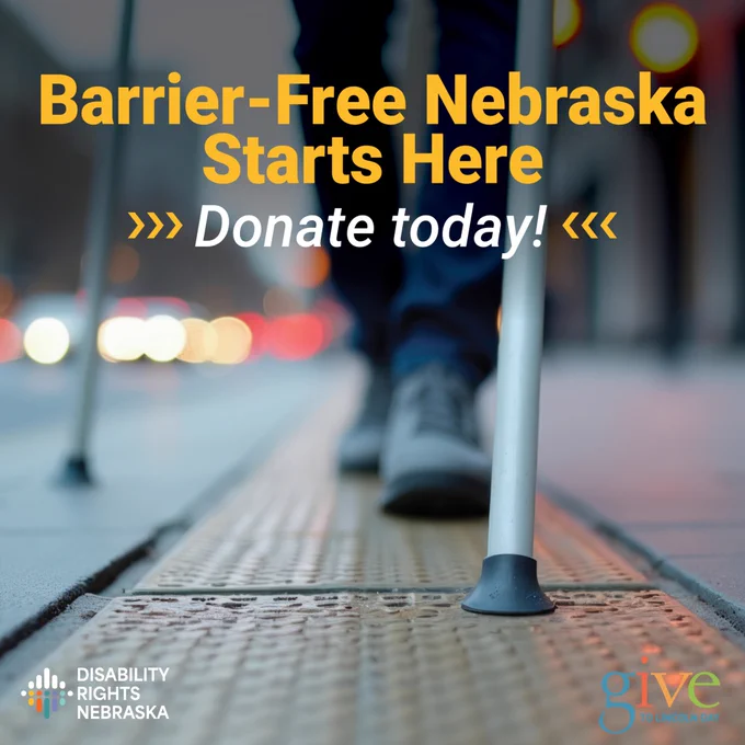 Close-up photo of a person using crutches while walking along a city sidewalk with tactile paving. The background is softly blurred with city lights. Large yellow and white text reads, “Barrier-Free Nebraska Starts Here — Donate today!” Logos for Disability Rights Nebraska and Give to Lincoln Day appear at the bottom corners.