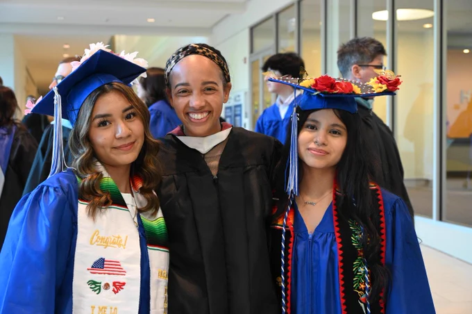 HP grads with a staff member