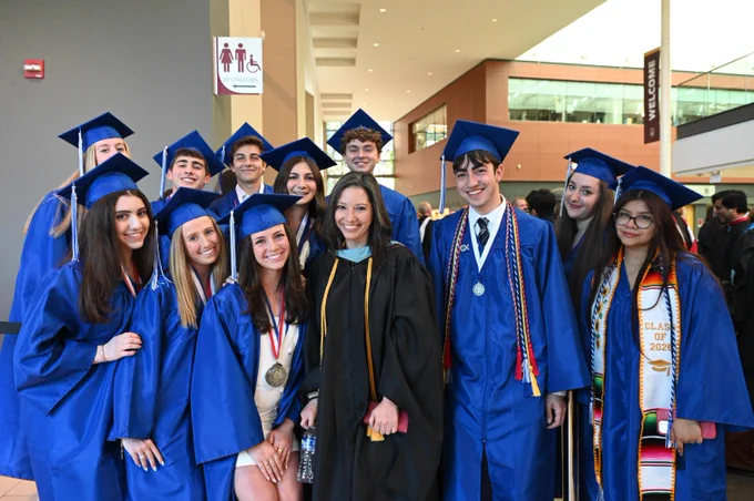 Principal Holly Fleischer posing with students