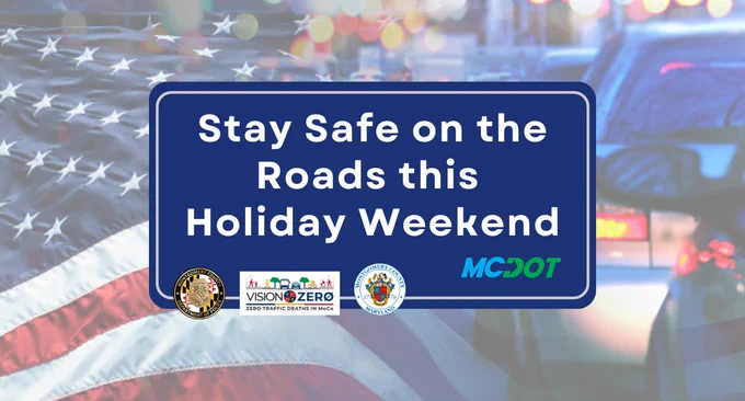 Blue road safety sign urging drivers to stay safe during the holiday weekend with logos from MCDOT and Vision Zero.