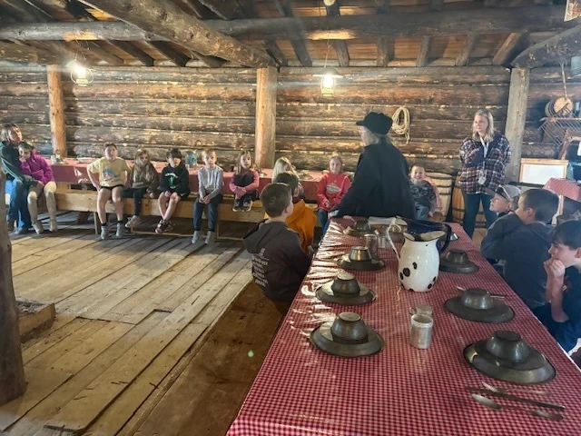students sitting at the forest history center listening to a speaker