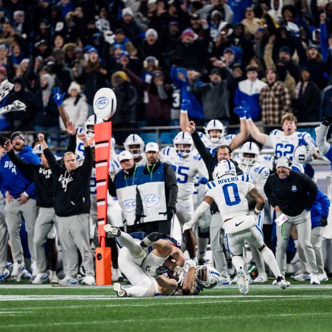 Duke linebacker Luke Mergott lays on the ground following his game-ending interception against Virginia in the 2025 ACC Football Championship, securing the Blue Devils' first outright ACC title since 1962.