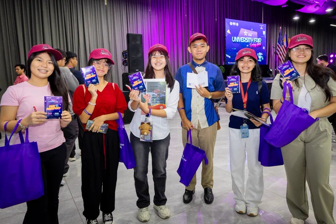 Fair participants holding their event passports.