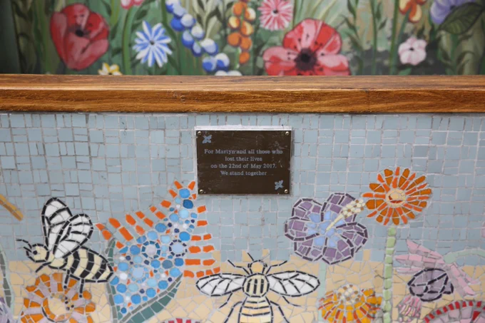 A photo of the memorial bench at Coronation Street. The plaque reads: \n\"For Matyn and all those who lost their lives on on the 22nd May 2017. We stand together.\"