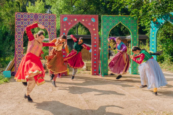 Dancers in colouful clothing performing outside 