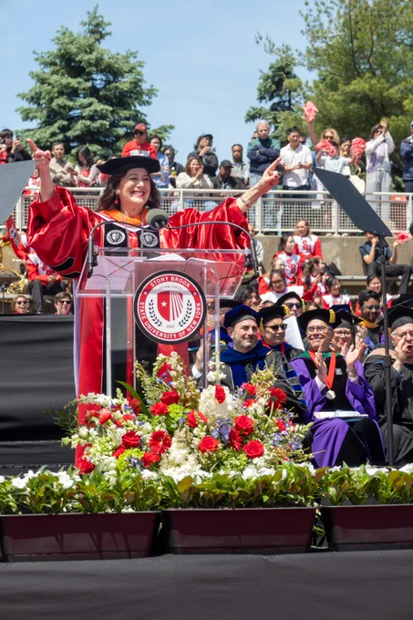 President Andrea Goldsmith speaking at a lectern on stage at the Stony Brook University commencement.