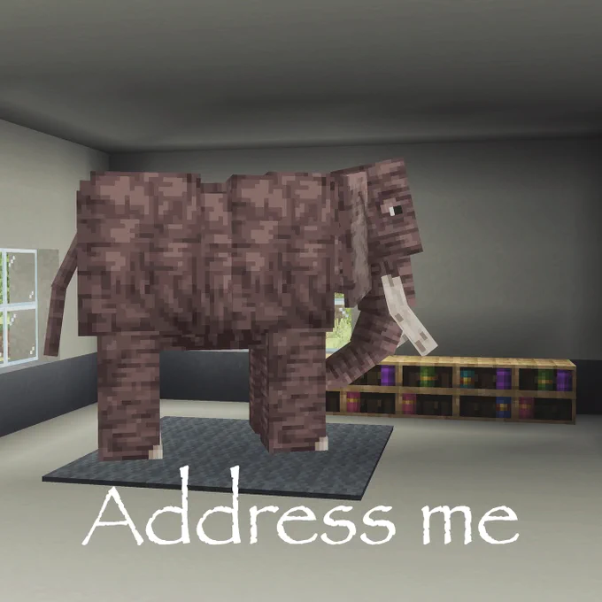 An elephant from the Minecraft Add-On, Animals Add-On, in a room with the text "Address me"