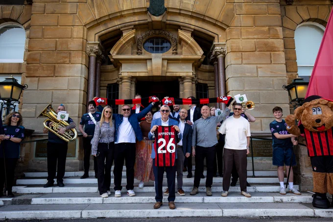 Members of AFC Bournemouth's backroom team, led by Jim Frevola, celebration planning approval with a shirt that says APPROVAL 26.