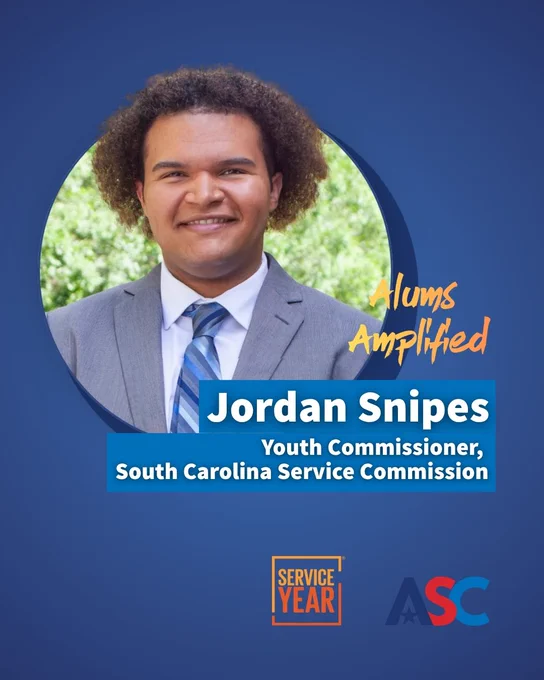 This image features a person smiling, wearing a suit and tie. The background includes a blurred view of greenery. Text on the image reads: "Alums Amplified, Jordan Snipes, Youth Commissioner, South Carolina Service Commission." Logos for Service Year and ASC are at the bottom.
