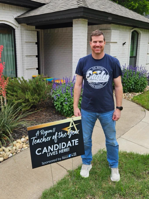 Jeff Neaves, Northwest ISD and VR Eaton High School Secondary Teacher of the Year, standing in front of a house with a yard sign that reads "a Region 11 Teacher of the Year Candidate Lives Here!" 
