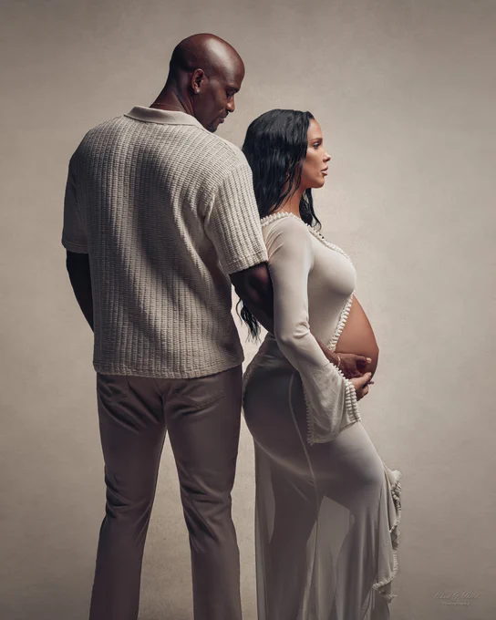 Celebrating pregnancy together in a studio maternity couples maternity photo session.