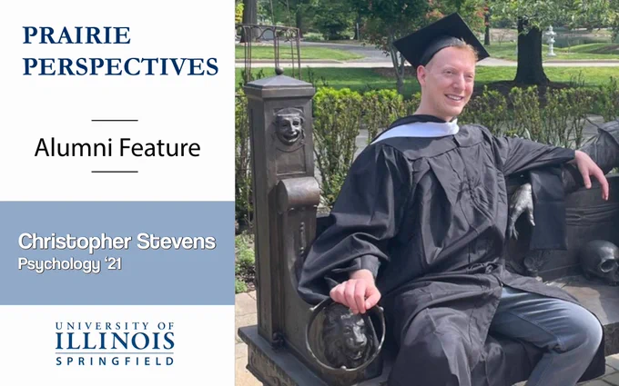 A graduate in cap and gown sits on a bench outdoors. Text reads “Prairie Perspectives, Alumni Feature, University of Illinois Springfield, Christopher Stevens, Psychology '21."