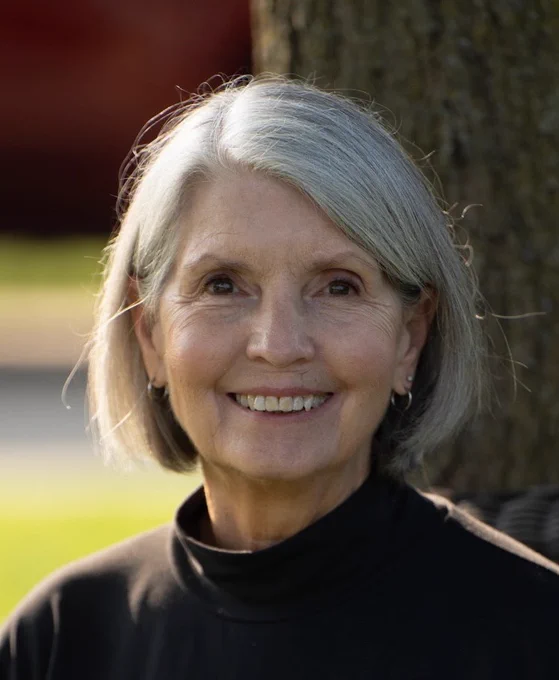 headshot of Patty Prewitt, an older woman with white hair and black shirt.